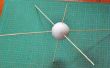 Cómo insertar pinchos perpendiculares uno al otro en una bola de espuma de poliestireno para que todos parecen venir desde el centro de la bola